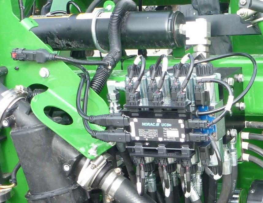 10.2 Valve Block Mounting 1. A good mounting location for the valve block on the John Deere is illustrated in Figure 27. This will require remounting the hose clamp as shown. 2. Insert the threaded rod into the block and use a hex nut to hold the rod.