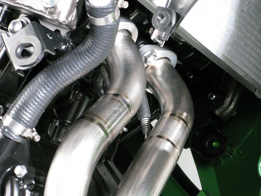 Insert the header pipes into the sleeves, attach springs and tighten the flanges to specified torque (Figure 12).