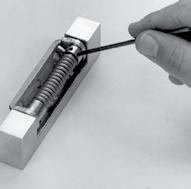 1220 hinge easily converts to spring hinge for self-closing applications. 1. Assemble spring cartridge as shown. 2.