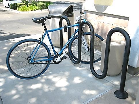 Required cover for bicycle parking spaces shall be permanent, designed to protect the bicycle