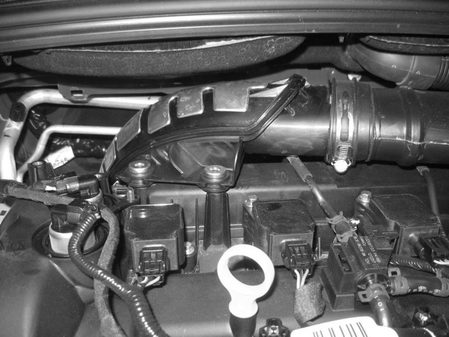 Remove the engine cover stud, using an open end wrench or deep socket from the cam cover.