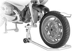 Raise the front of the motorcycle until the front wheel can rotate freely. BMW Motorrad recommends the BMW Motorrad front wheel stand for lifting the motorcycle.