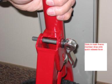 2. Attach frame onto lever by dropping the slots in main frame tube over the quick release lever. Tighten with nut.