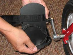The screw fits through the seat back and the slot between the rods. Add the larger fender washer and tighten with the t- shaped knob. Note: Black straps install through back of seat back.
