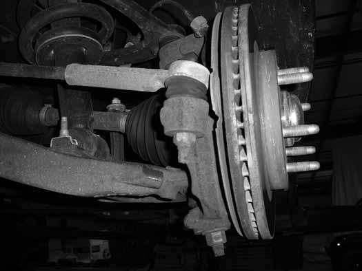 6. Remove the nut from the steering tie rod end. Figure 3 Thread the nut back on a couple of turns by hand. Strike the knuckle near the tie rod end to dislodge the rod end taper from the knuckle.