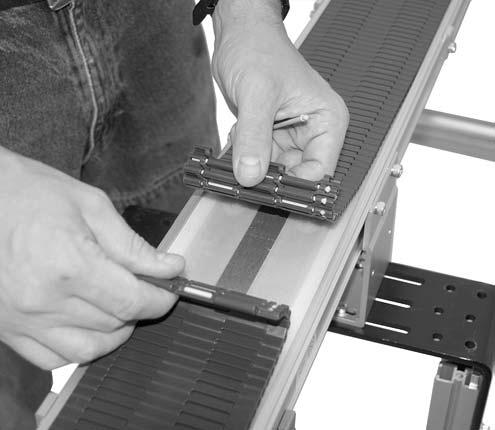 Preventive Maintenance and Adjustment IMPORTANT You may need to slightly raise the underside of the conveyor belt to properly drive pin out of slots.