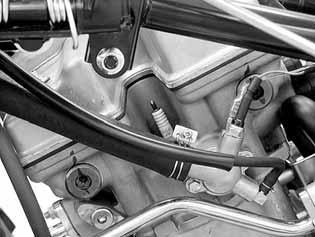 Remove the spark plug using a equipped spark plug wrench or an equivalent tool. Inspect or replace as described in the maintenance schedule.