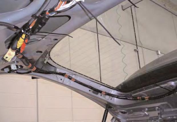 USE THE FACTORY WIRE CHANROUTE THE HARNESS ALONG THE FLOOR UNDER THE LEFT REAR TRIM PANELS AND UP THE LEFT D-PILLAR HARNESS ROUTING ABOVE THE HEADLINER TO THE