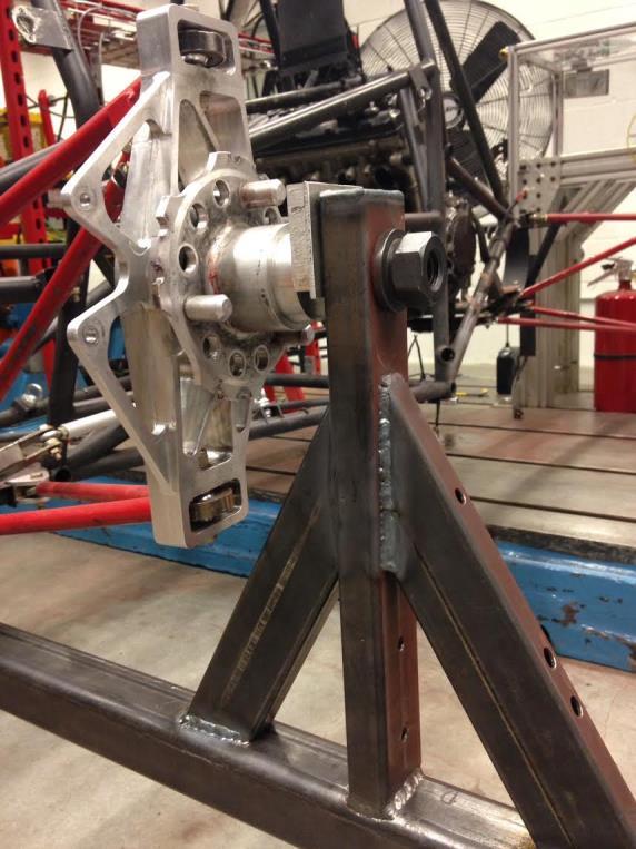 The only motion that has not been constrained is pitching of the frame, which the front pivot point constrains. The rear end fixture was made out of rectangular 4130 steel sections.