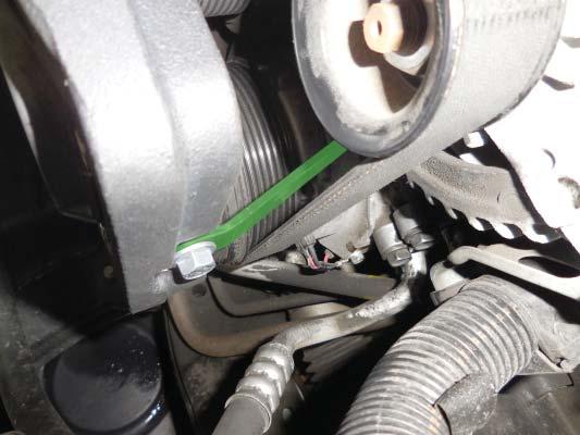 105. Using the bolt removed in the previous step, attach one end of the supplied tensioner support bracket (highlighted in green