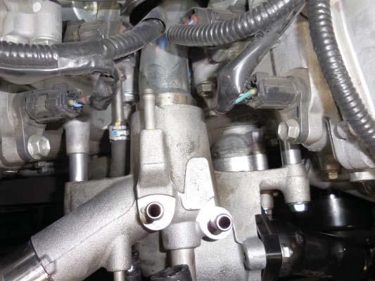 113. Install the thermostat water manifold back onto the engine making sure the 2 O-rings are