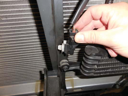 Unclip the temperature sensor from the hood