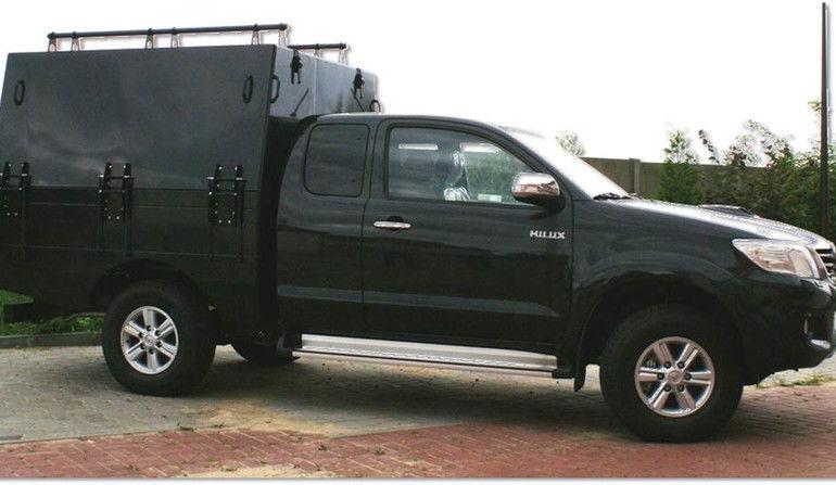 Toyota Hilux featuring the Kusza system, with the system folded up into the transport setting, does not look like a military vehicle.