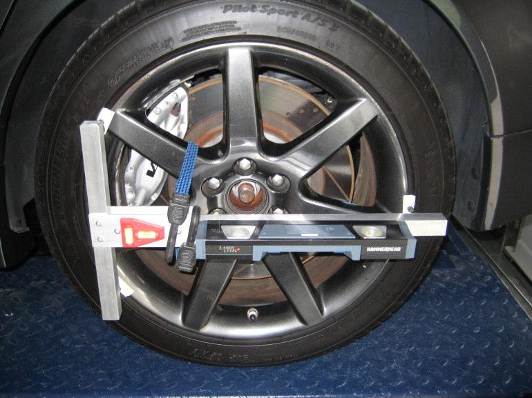 The proper way to conduct a four-wheel alignment with hand-held tools is to begin with measurements at the rear of the car.