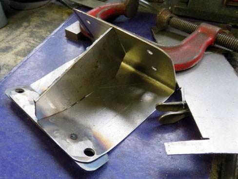To hold the plate at the correct angle, and to stop it bending in use, a brace was