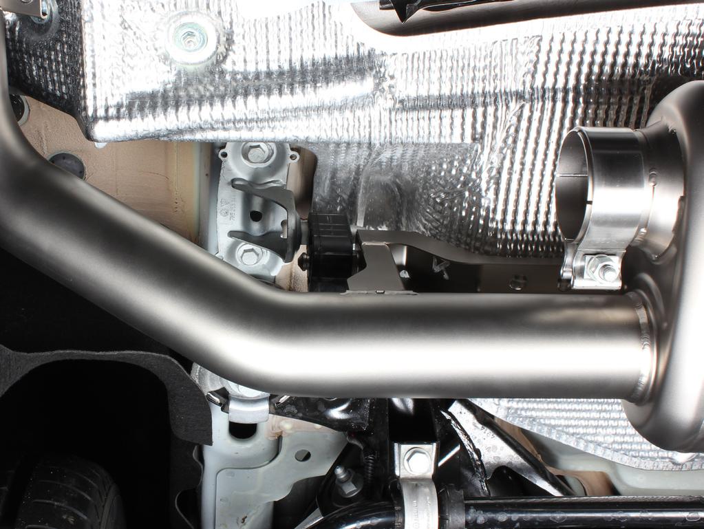 5. Tighten the stock muffler rubber brackets onto the chassis (using stock bolts) on both sides of the vehicle (F 12).