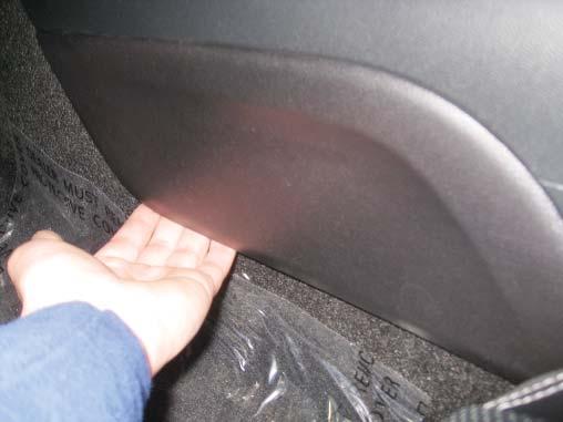 Re-install the rear quarter trim panel and the bottom portion of the rear seat by reversing