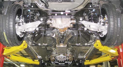 3. Unhook each exhaust hanger from the sub frame and remove each muffler assembly by