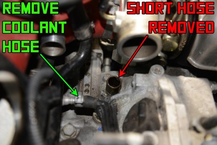13. Remove the PCV fitting and the small section of rubber hose from the port on the engine block, as shown in RED. Also disconnect and remove the coolant hose shown in GREEN.