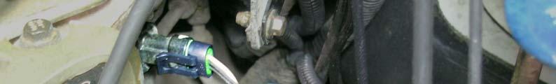 located to the rear of the fuel filter housing near the top