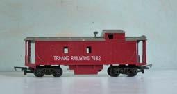 3.136 Tri-ang R115 bogie Caboose, maroon with grey roof, lettered 'Tri-ang Railways 7482' in white on each side. No shield. Stove chimney and all steps intact. Tension-lock couplings.