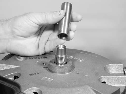 Leave flywheel puller attached to flywheel and place on clean work surface with ring gear side down until flywheel is ready to be installed. Note: Use extreme care when handling flywheel.