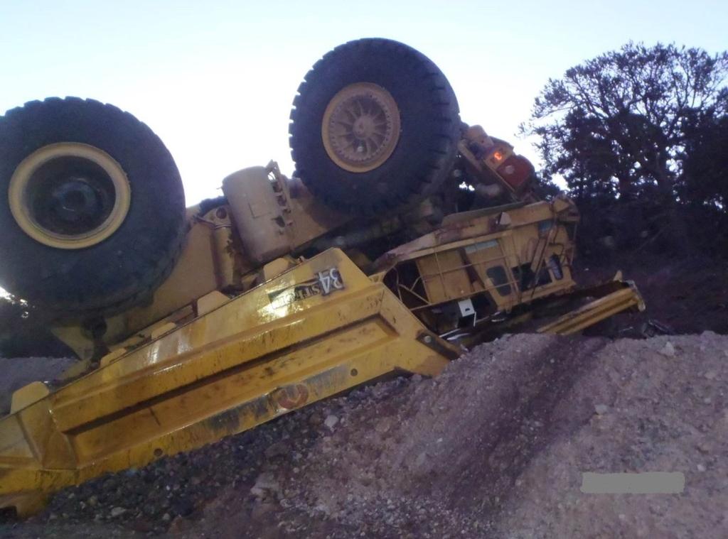 A haul truck operator lost control while traveling down a haul road. The truck struck a berm causing the truck to cross the road and travel through another berm.