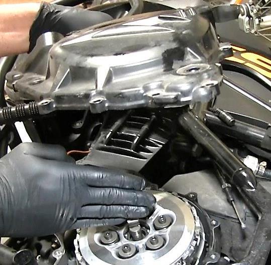 Use the channel-lock pliers to reattach the clutch cable to the clutch cover and the actuator arm. 16. Stand the bike up, supporting it on its kickstand or center stand.