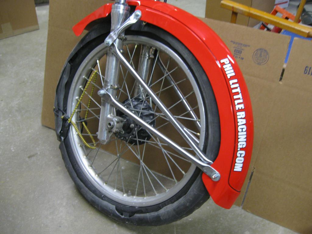 The length of your front fender is a given-it must go below the axle line. This means you can t mount the front in wheel chocks. You have to back the bike into the chokes.