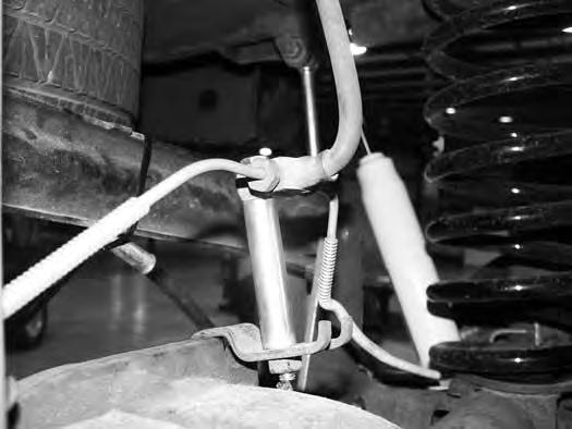 FIGURE 8 29. Reattach the parking brake cable to the driver s side axle mount with the original hardware. 30.