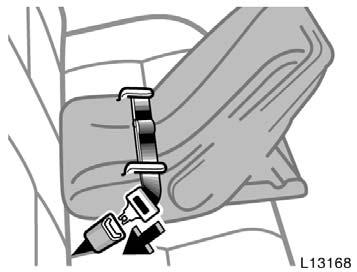 Run the center lap belt through or around the infant seat following the instructions provided by its manufacturer and insert the tab into the buckle taking care not to twist the lap belt.