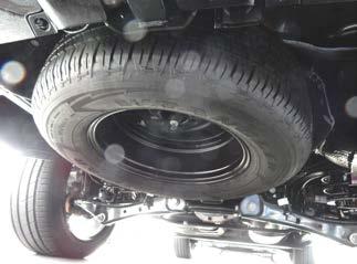 JACKING AND TIRE SERVICE: Note: Chock the tires and set the parking brake to ensure the vehicle will not move.