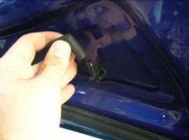C. Remove fasteners that attach the hose to the hood with a fork tool.