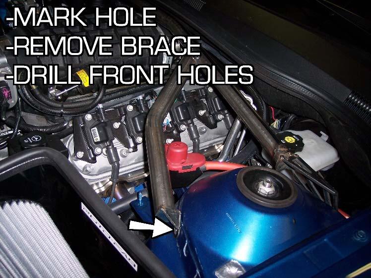 11. With the strut brace in place you can now mark the front holes with a marker. Mark the center of the front bracket slot on each side. Remove the strut brace from the vehicle. 12.