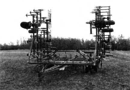The rigid hitch link and hitch jack made one-man hitching easy (FIGURE 8). Hitch weight was positive in transport and eld position with mounted harrows.