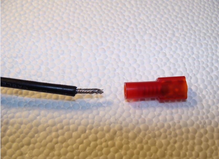 c. Place a flat spade terminal (included in kit) on the other end of the BLACK 20g POSITIVE wire.