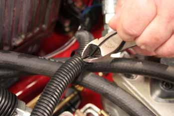 12. Install a cable tie securing the wire harness and 2 low pressure hydraulic hoses (Fig. 058). 14.