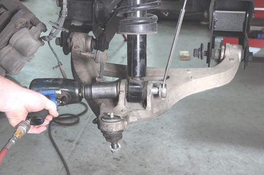 33. Install the strut in the mount on the lower control arm using the factory hardware.