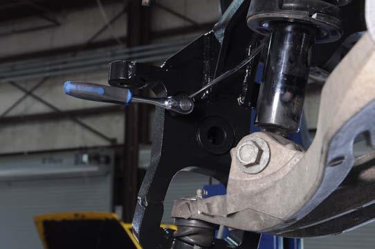 Tighten the upper ball joint nut using a 0mm and 22mm wrench.
