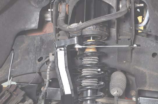 Tighten the lower ball joint nut using a 22mm wrench and
