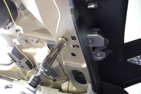 Locate the M8 bolts that secure the two rear seat lock receivers to the trunk ceiling.