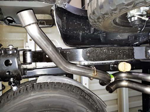 16. Install the 3" pipe onto the muffler and slide the hanger onto the leaf spring shackle bolt.