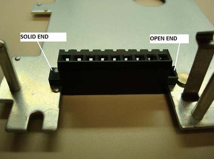 Note, the angled edge of the terminal block must face down and the block must be inserted such that the dimples on the mounting plate restrain the blocks