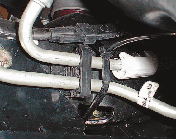 Remove the plastic bracket holding the metallic cooling lines from the passenger side of the truck frame.