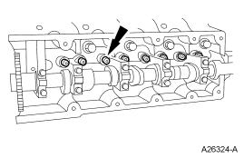 Cylinder head warpage can result if a warm or hot cylinder head is removed. CAUTION: Place clean shop towels over exposed engine cavities.