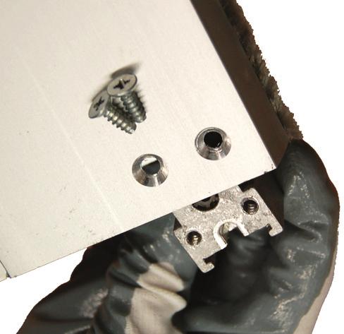3) Reinstall the bracket and retaining fasteners within the exit device housing.