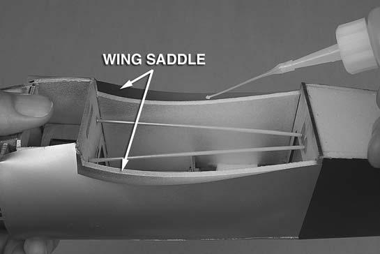 When satisfi ed with the fi t, apply a generous bead of foam-safe CA to both wing saddles on the fuselage, and then place