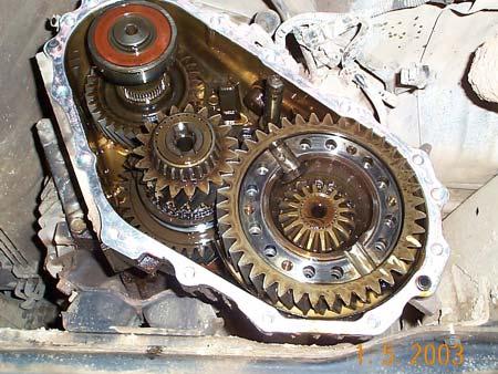 Remove the large snap ring from the outside of the transfer case input shaft rear bearing. 7. Remove the 8 bolts holding the centre housing to the front housing.