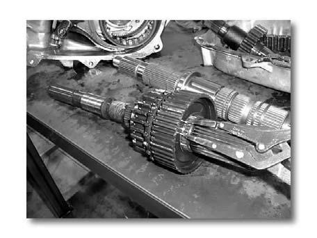 Page 5 of 11 (Fig. 9) Oil Pump Removal (11) Disconnect the pump pickup tube visible at lowest point of tailhousing opening. (Fig. 9) (a) Remove the pump from the main output shaft.