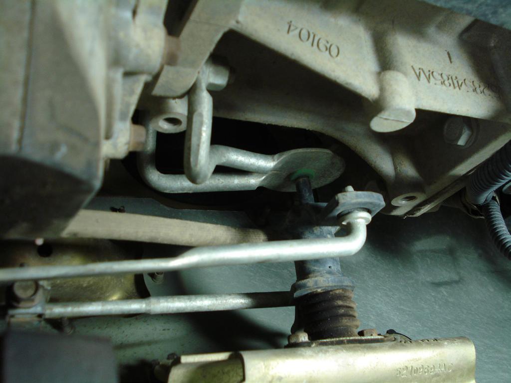 Take the new shifter housing and apply butyl tape around the perimeter of the shifter box. Figure 13: Remove Shifter Linkage 13.